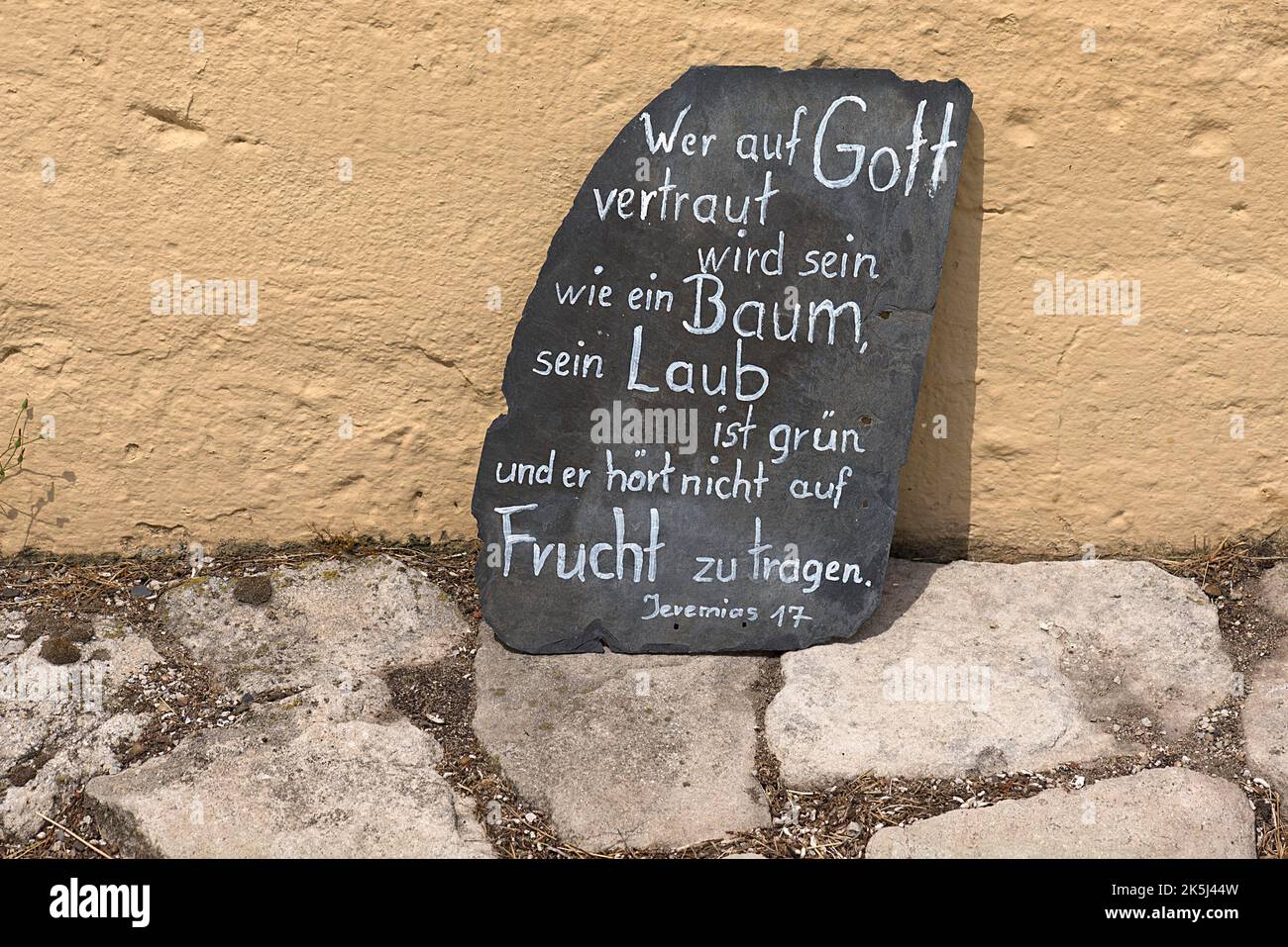 Bible verse on a slate leaning against a chimney wall, Lower Franconia, Bavaria, Germany Stock Photo
