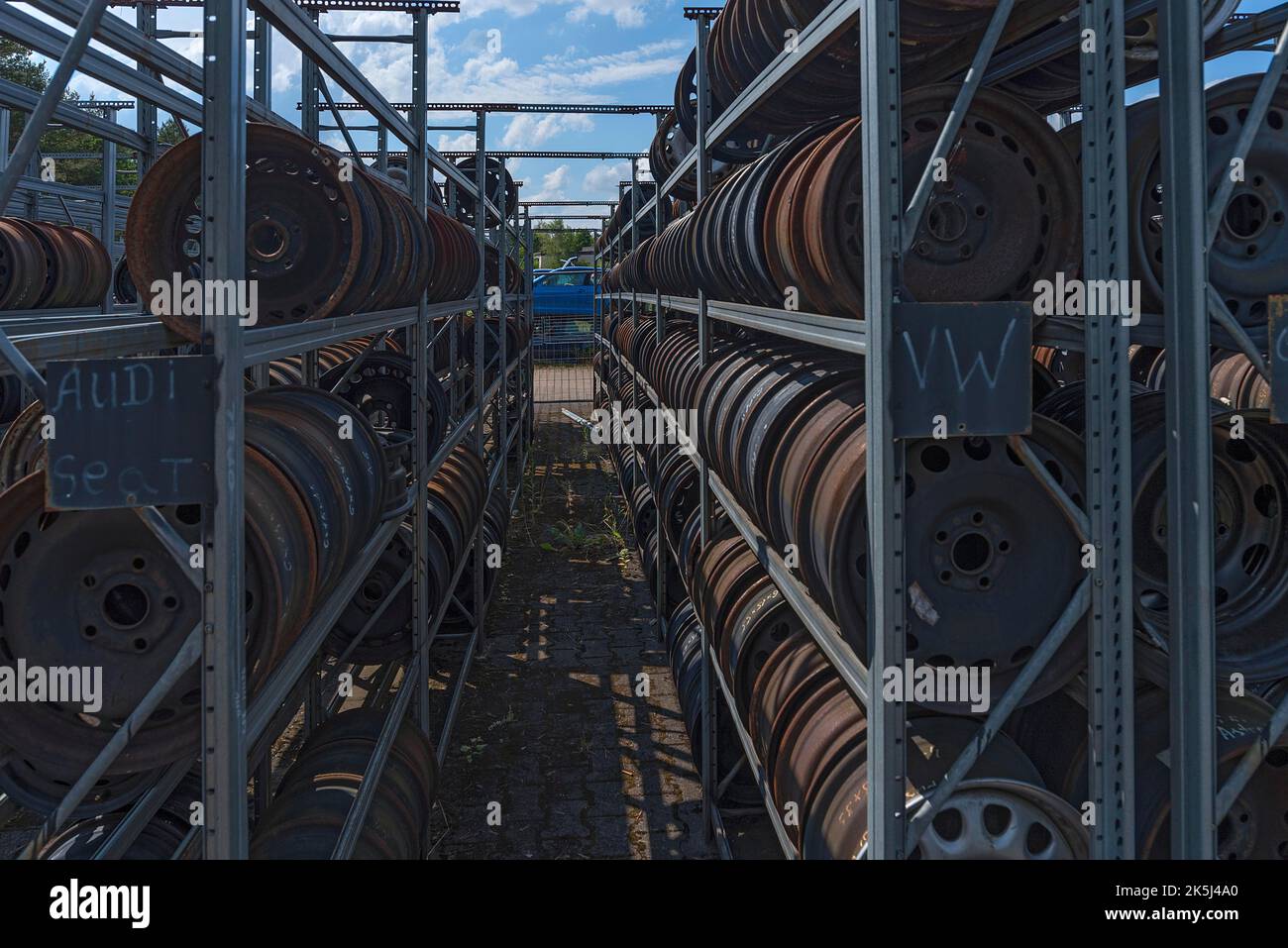 Shelf storage with sorted car rims at a scrap yard, Bavaria, Germany Stock Photo