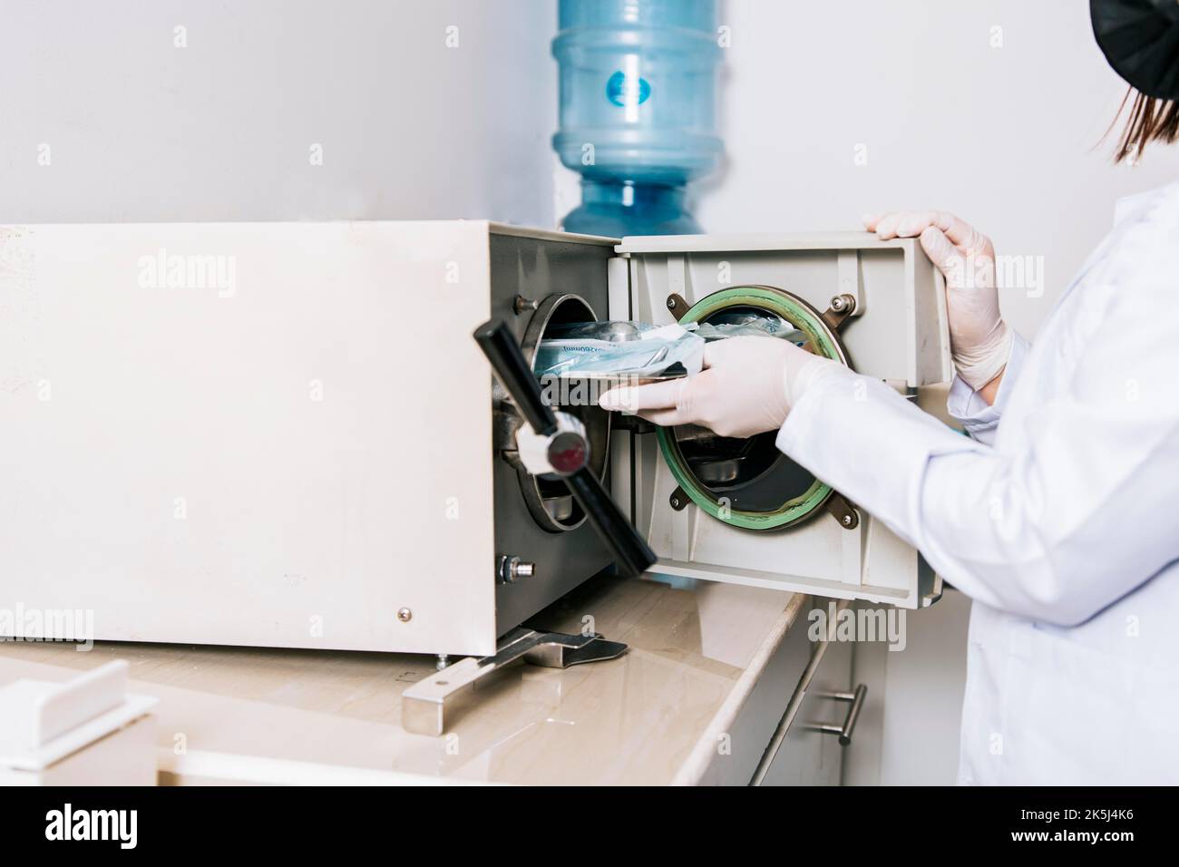 Dentist with dental sterilizer, Dentist hands sterilizing his tools