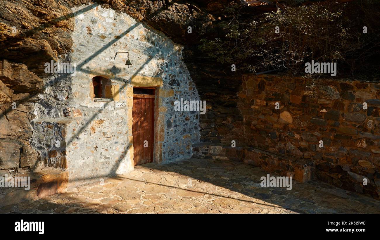 Agios Onoufrios rock church, paved forecourt, small bell, shade, Ravdoucha, Rodopou peninsula, western Crete, island of Crete, Greece Stock Photo