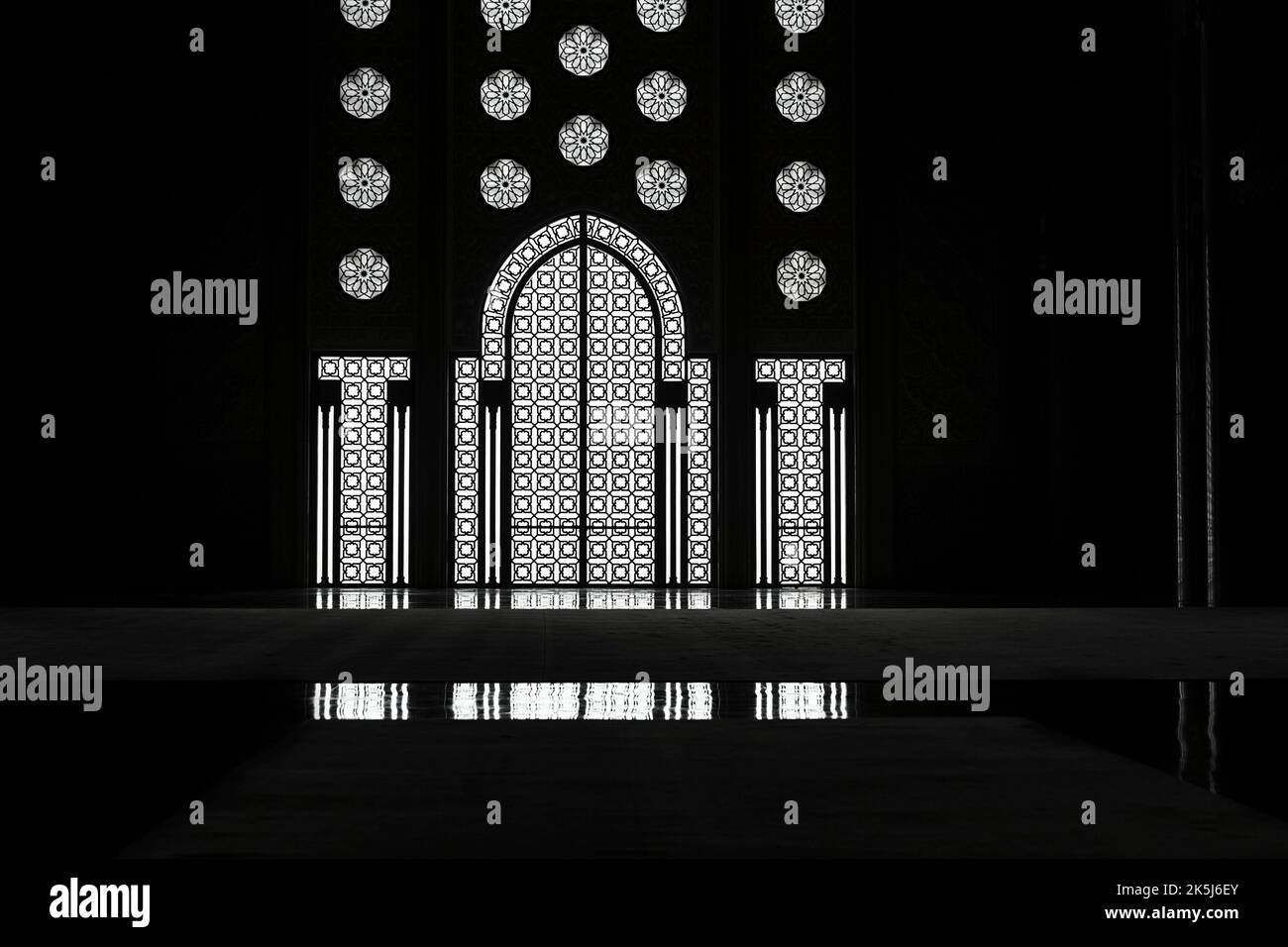 Light incidence in the darkness, interior door and window, arabesque, ornaments in the Hassan II Mosque, backlight with reflection, architecture Stock Photo