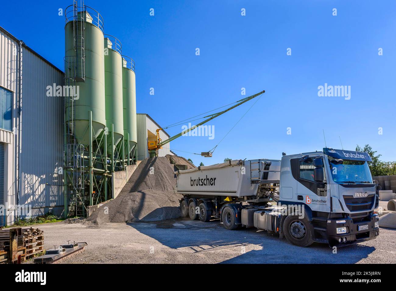 Steel silos. Low loader and bucket crane, precast concrete plant, Kempten, Allgaeu, Bavaria, Germany Stock Photo