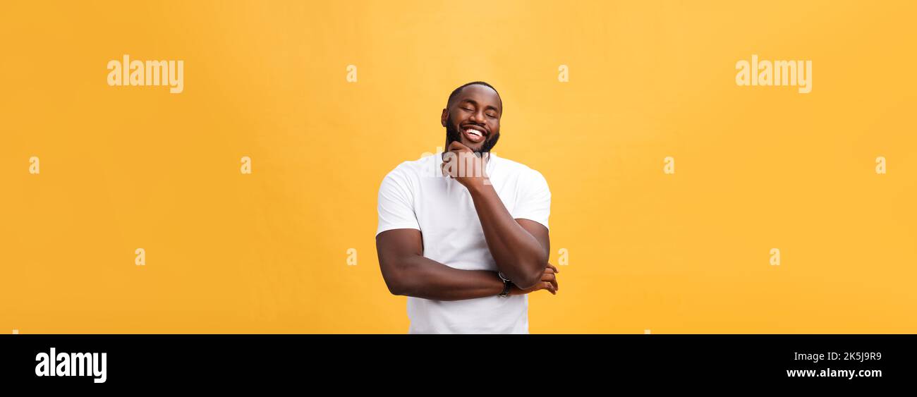 Portrait of a modern young black man smiling with arms crossed on ...