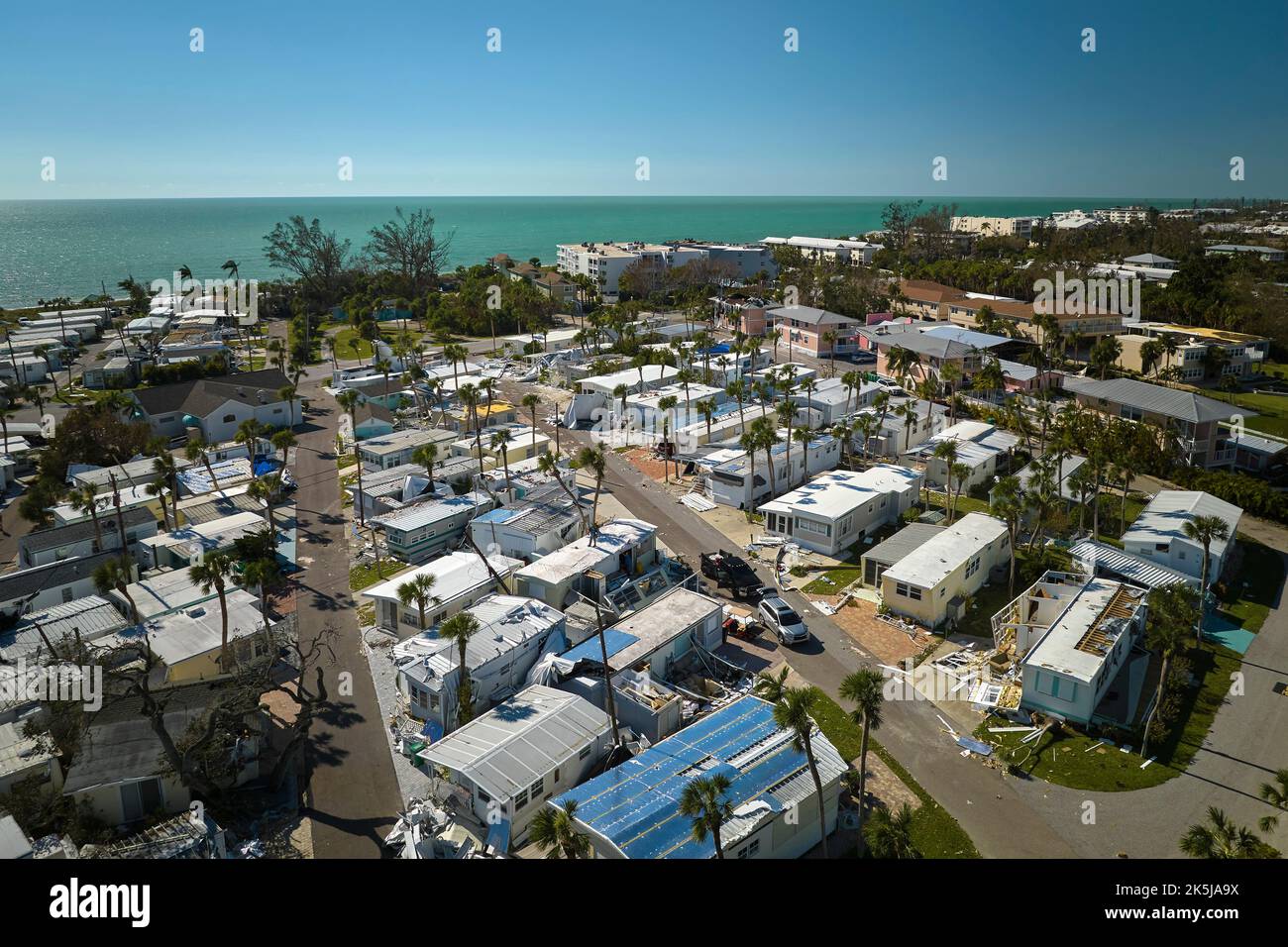 Badly damaged mobile homes after hurricane Ian on Manasota beach in