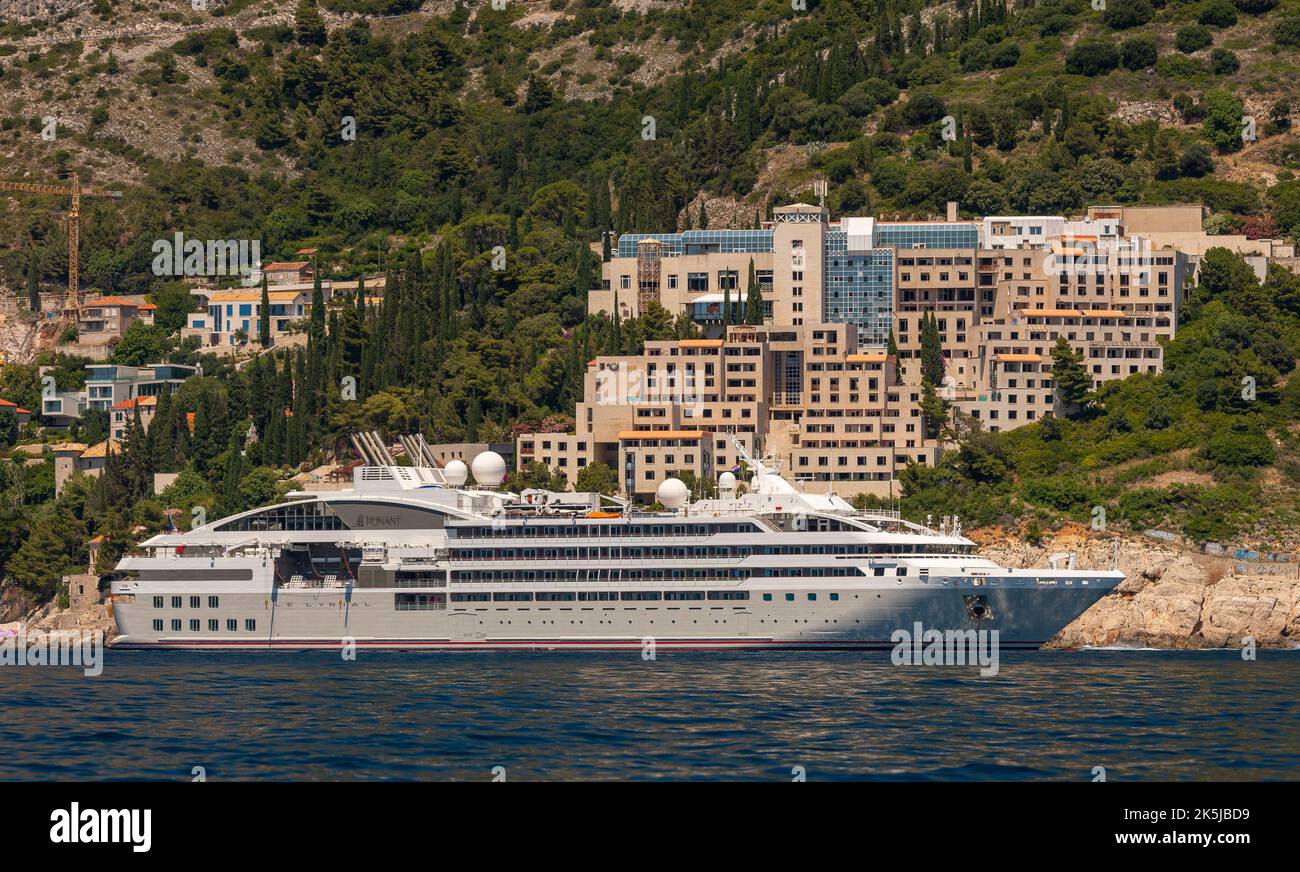 DUBROVNIK, CROATIA, EUROPE - Cruise ship Le Lyrial anchored in front of abandoned Hotel Belvedere, near Dubrovnik. Stock Photo