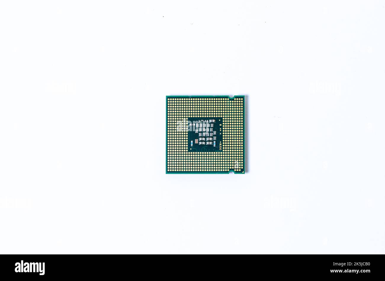 Computer processor CPU  Central processing unit microchip  isolated on white background Closeup  the bottom side, socket contact for personal computer Stock Photo