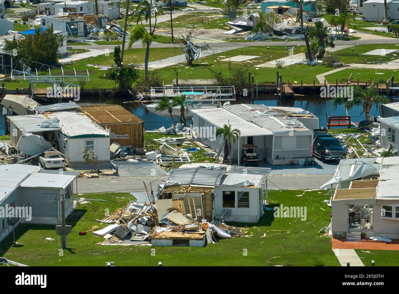 Severely damaged houses after hurricane Ian in Florida mobile home