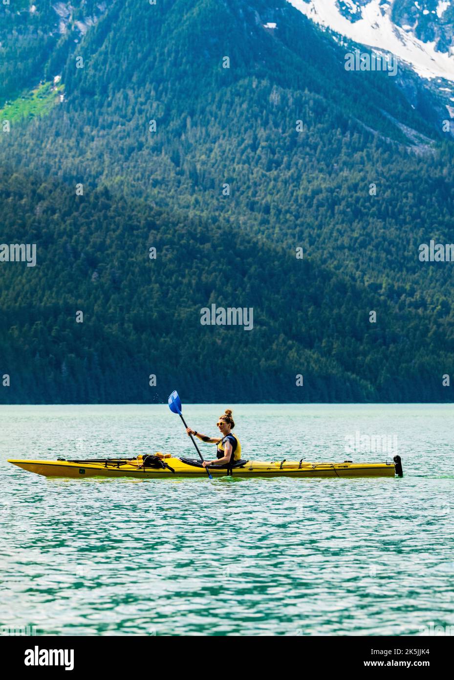 Colorful kayakers; Chilkoot Lake; Chilkoot State Recreation Site; Coast Mountains; Haines; Alaska; USA Stock Photo