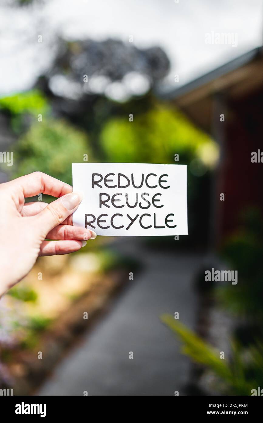 reduce reuse recycle sign in front of backyard bokeh, concept of ...