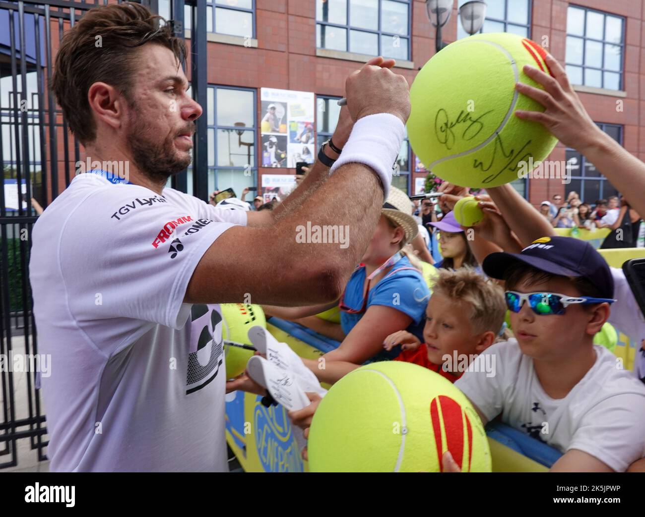 Grand Slam Champion Stan Wawrinka of Switzerland signs autographs after