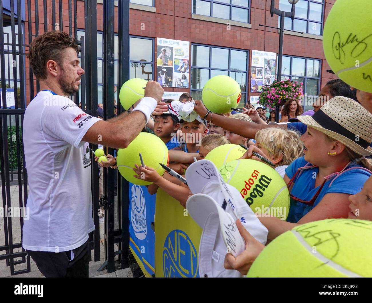 Grand Slam Champion Stan Wawrinka of Switzerland signs autographs after