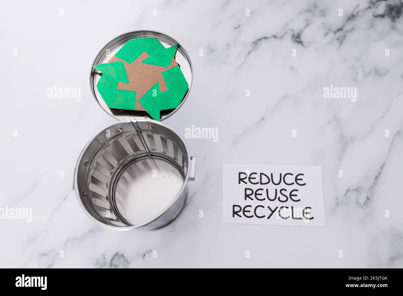 reduce reuse recycle sign with mini trash can and recycle icon, concept