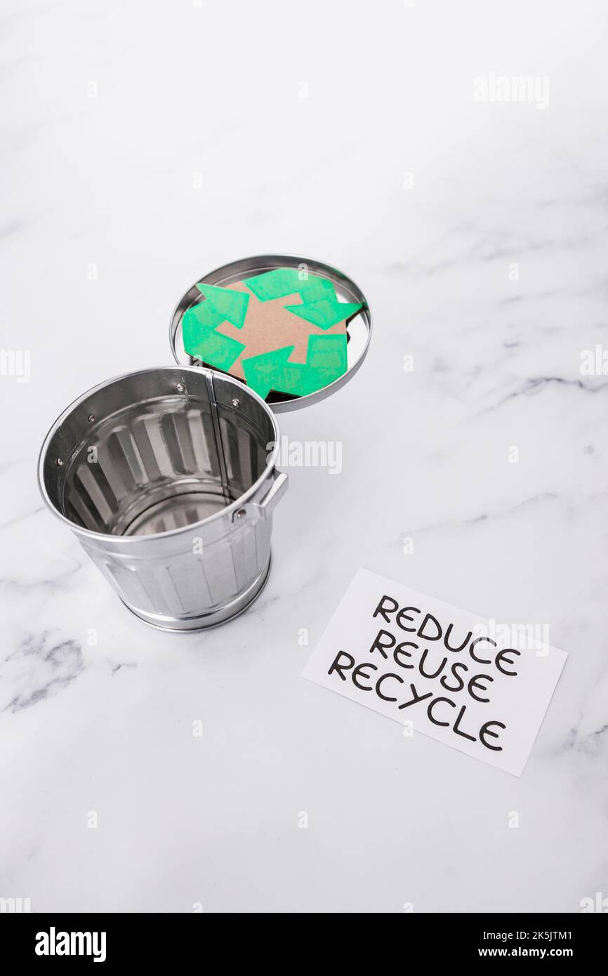 reduce reuse recycle sign with mini trash can and recycle icon, concept