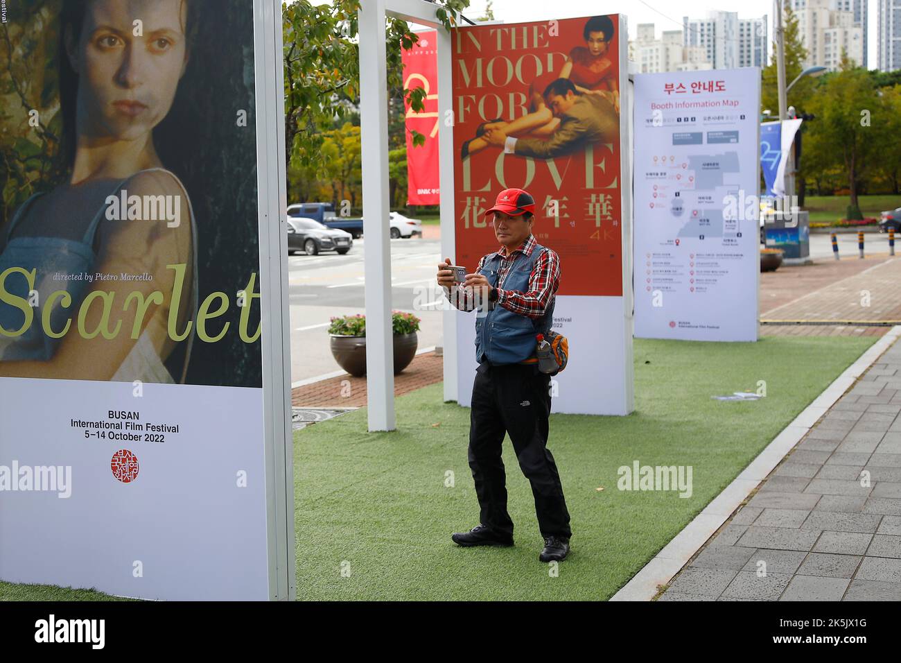 Oct 5, 2022-Busan, South Korea-Visitor take a picture a  event film poster at near cinema square in Busan, South Korea. Stock Photo