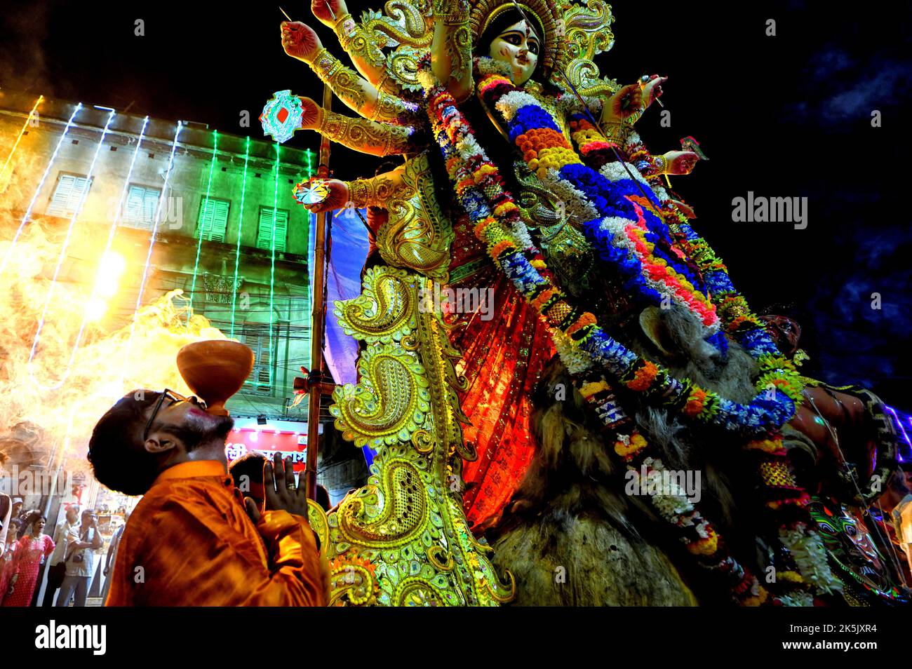 Kolkata, India. 06th Oct, 2022. A devotee performs rituals during the immersion procession of