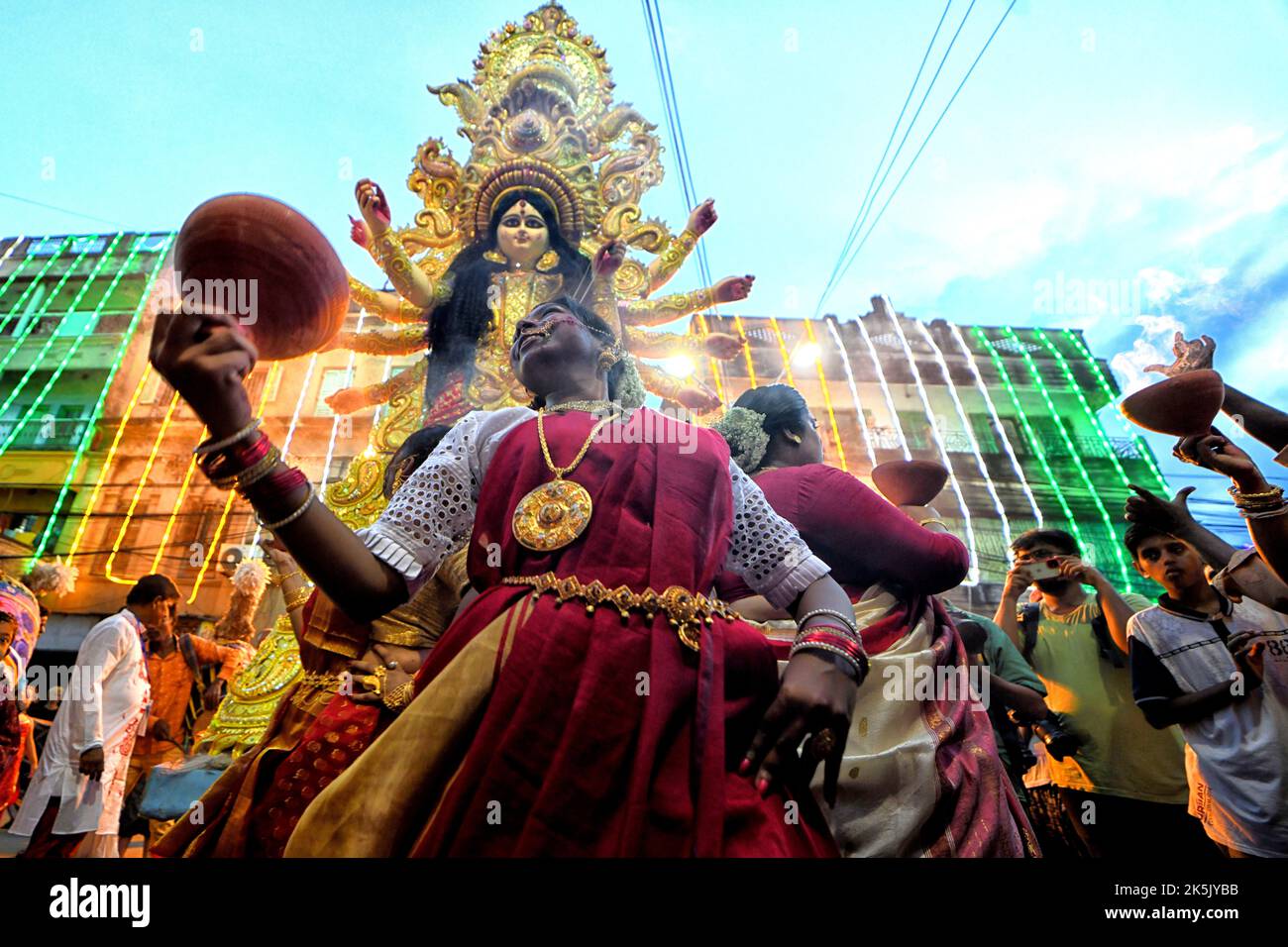 A devotee performs rituals in front of the idol of goddess Durga during