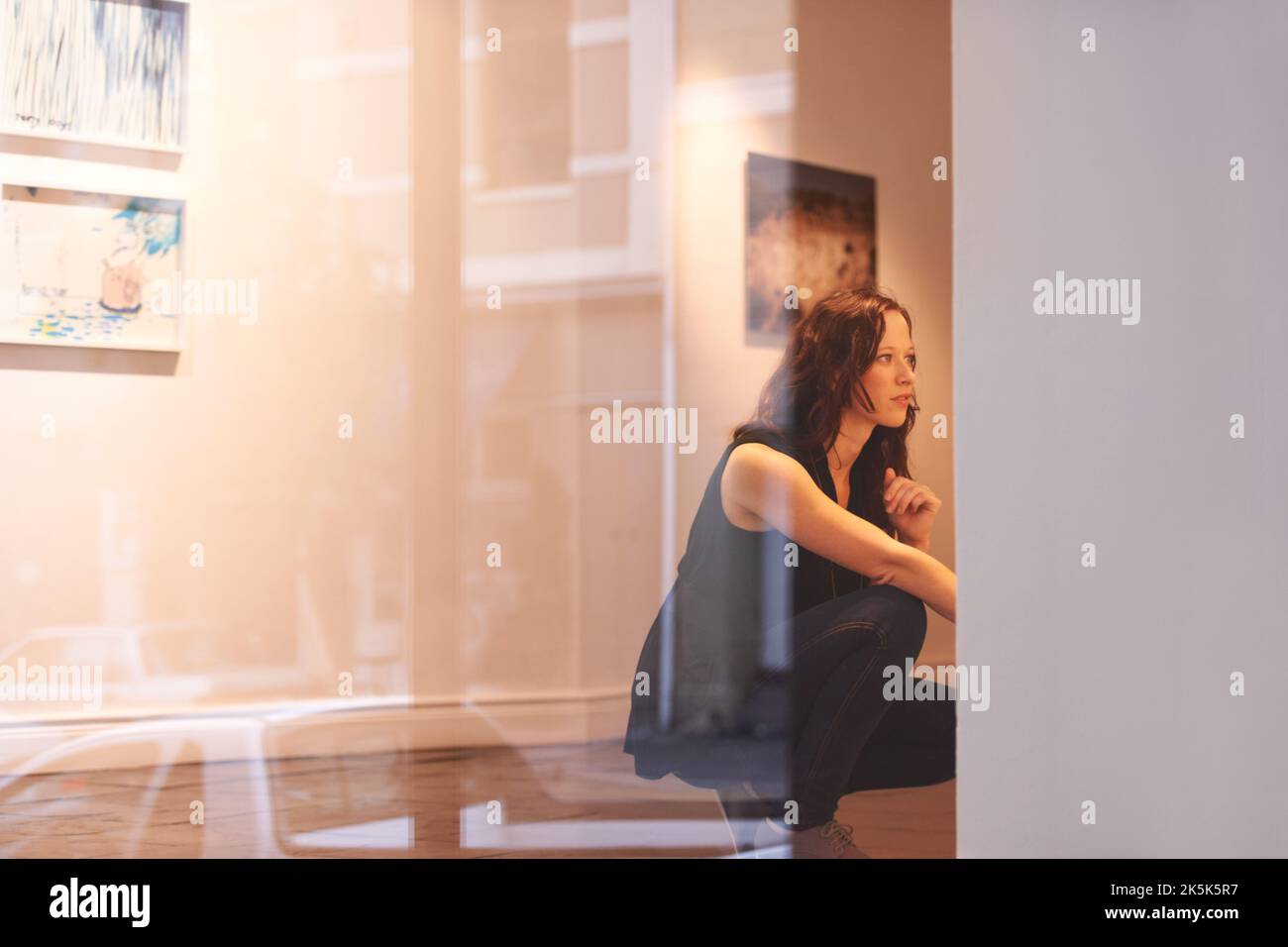 Taking in a century of art. a young woman looking at paintings in a