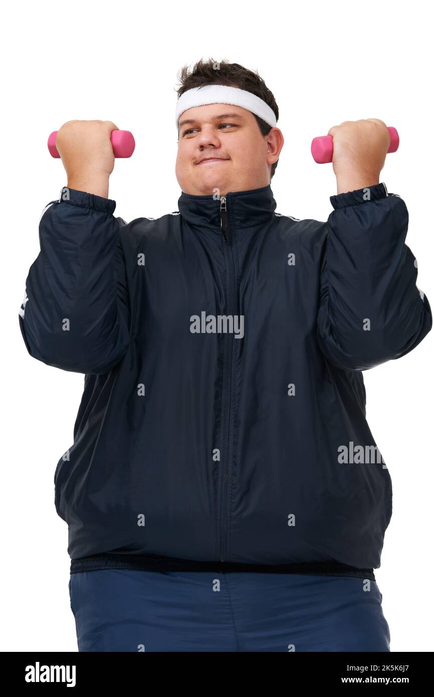 Its a deep burn. A studio shot of an obese man lifting weights and exerting himself. Stock Photo