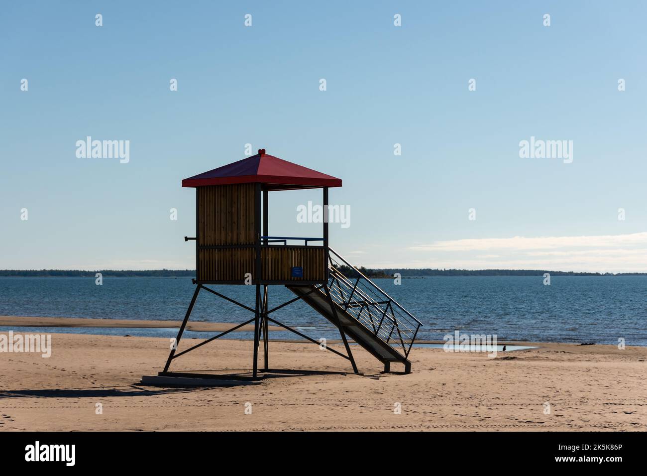 Wooden lifeguard tower with a red roof on the sandy beach of Yyteri in Pori, Finland with clear blue sky in the background Stock Photo