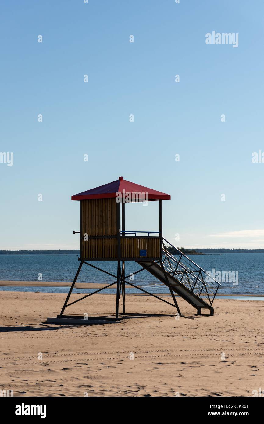 Wooden lifeguard tower with a red roof on the sandy beach of Yyteri in Pori, Finland with clear blue sky in the background Stock Photo