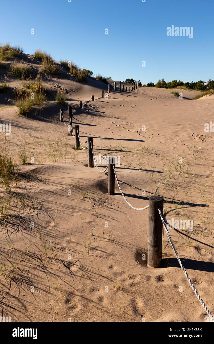 Rope fence with wooden posts on a sandy beach with dunes in Yyteri, Pori, Finland Stock Photo