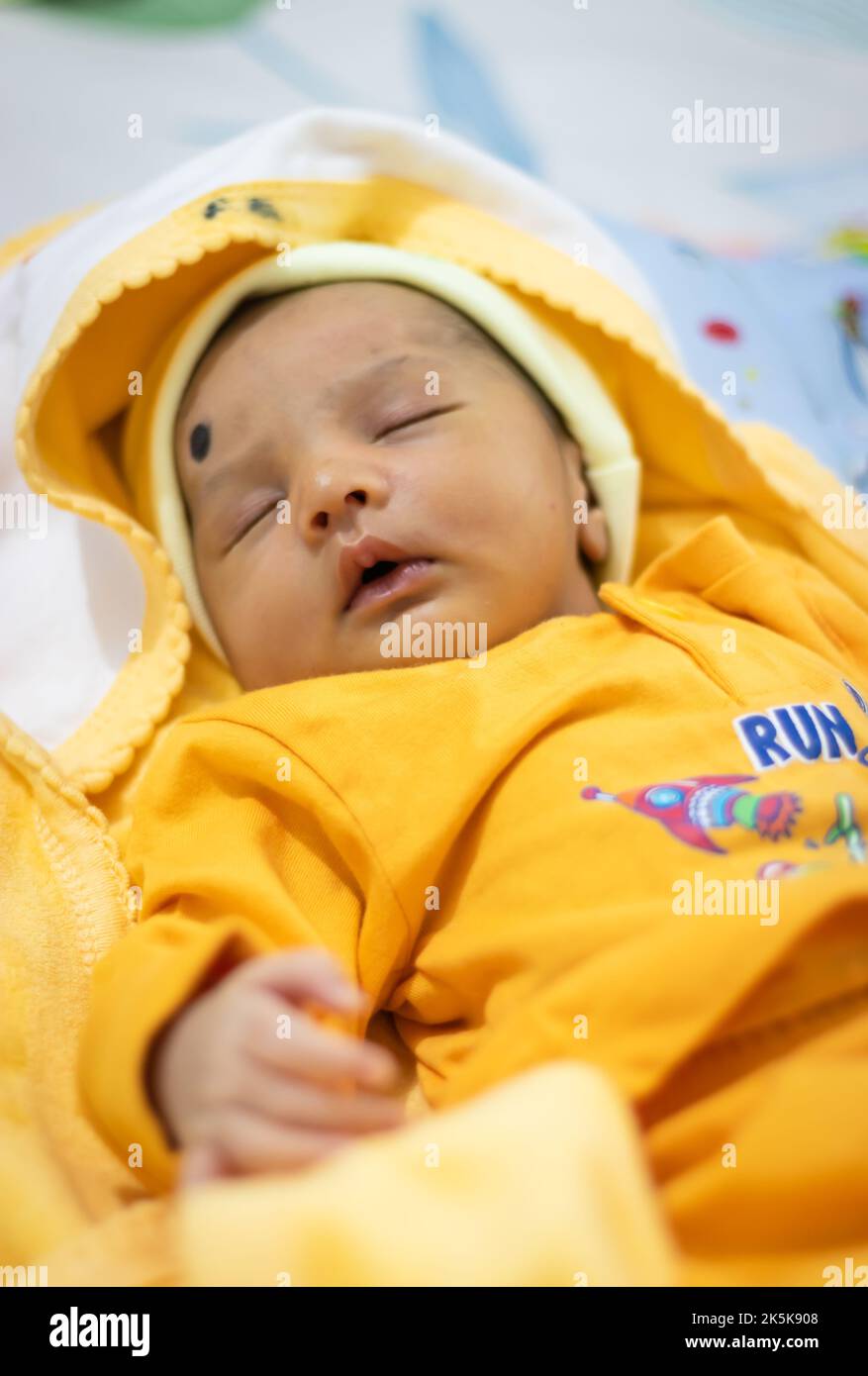 cute newborn baby sleeping in yellow dress from top angle Stock Photo Alamy