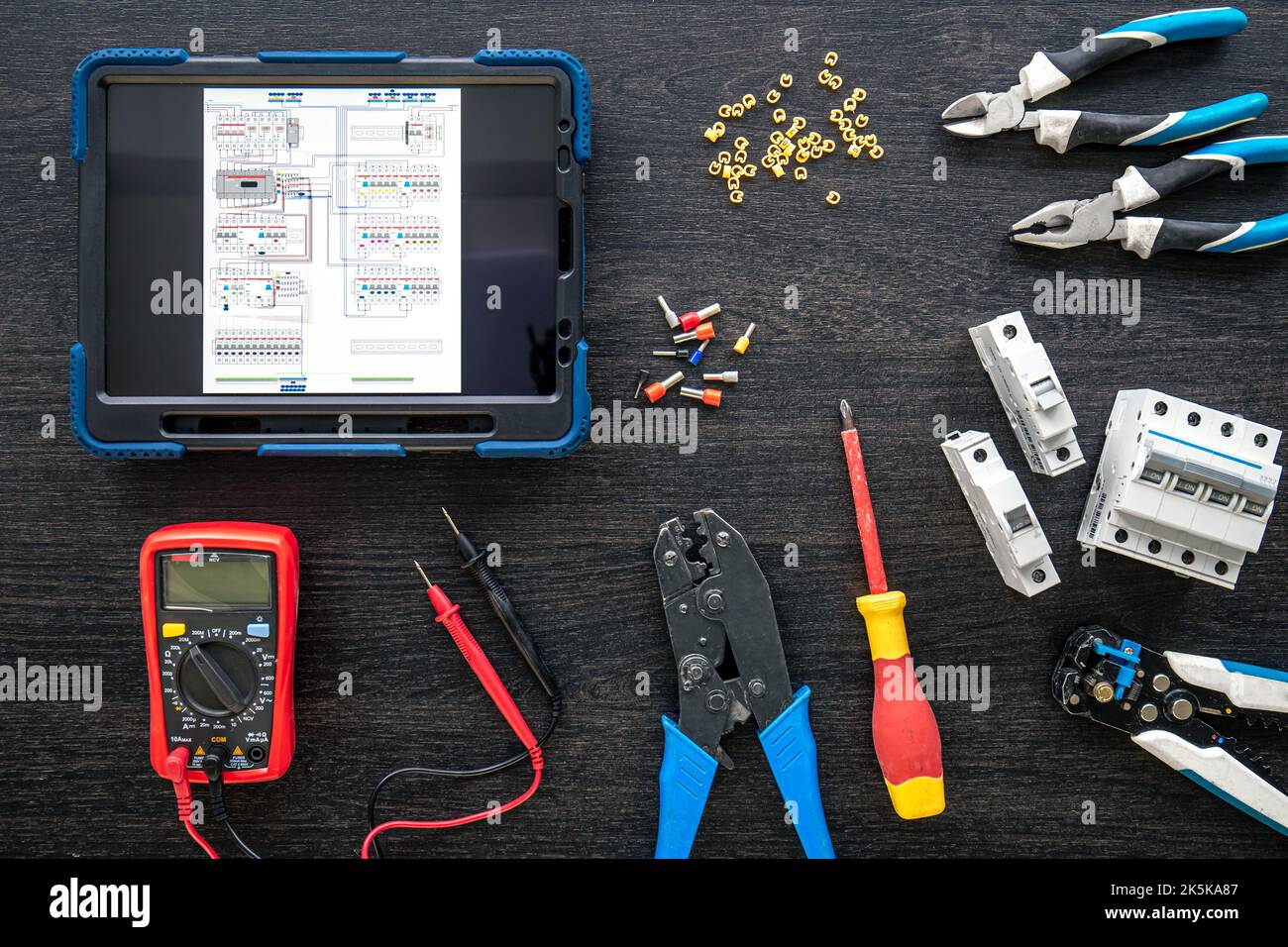 Different electrical tools and digital tablet on wooden background, flat lay. Stock Photo