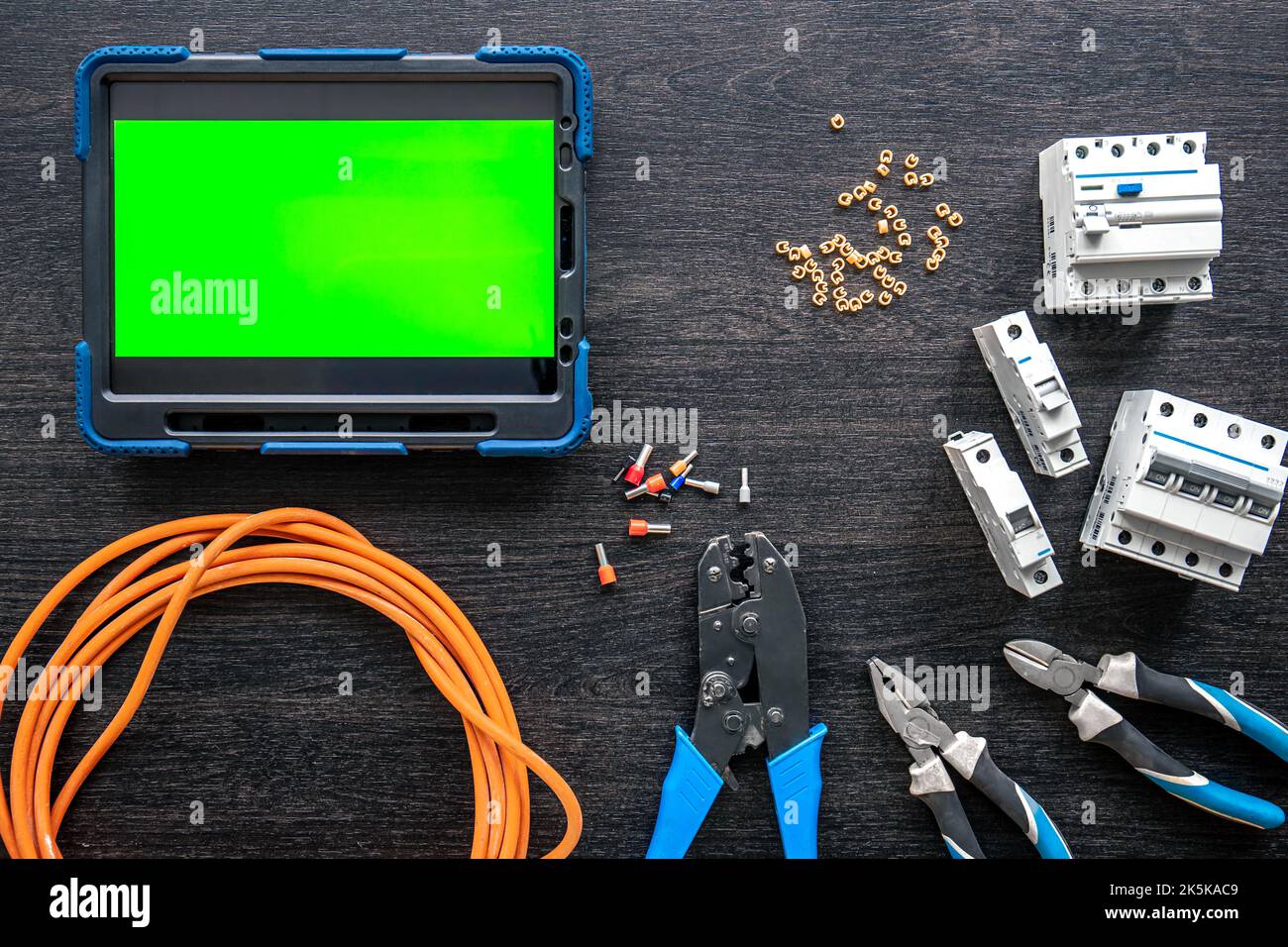 Different electrical tools and digital tablet on wooden background, flat lay. Stock Photo