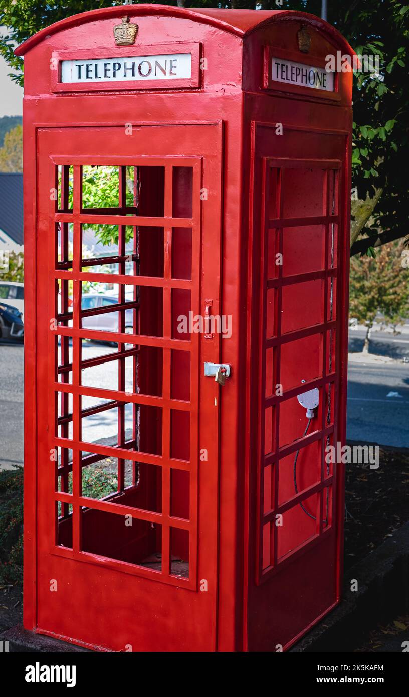 Classic British red phone booth on a city street. Traditional red british telephone box. Historical architecture. Nobody, travel photo, selective focu Stock Photo