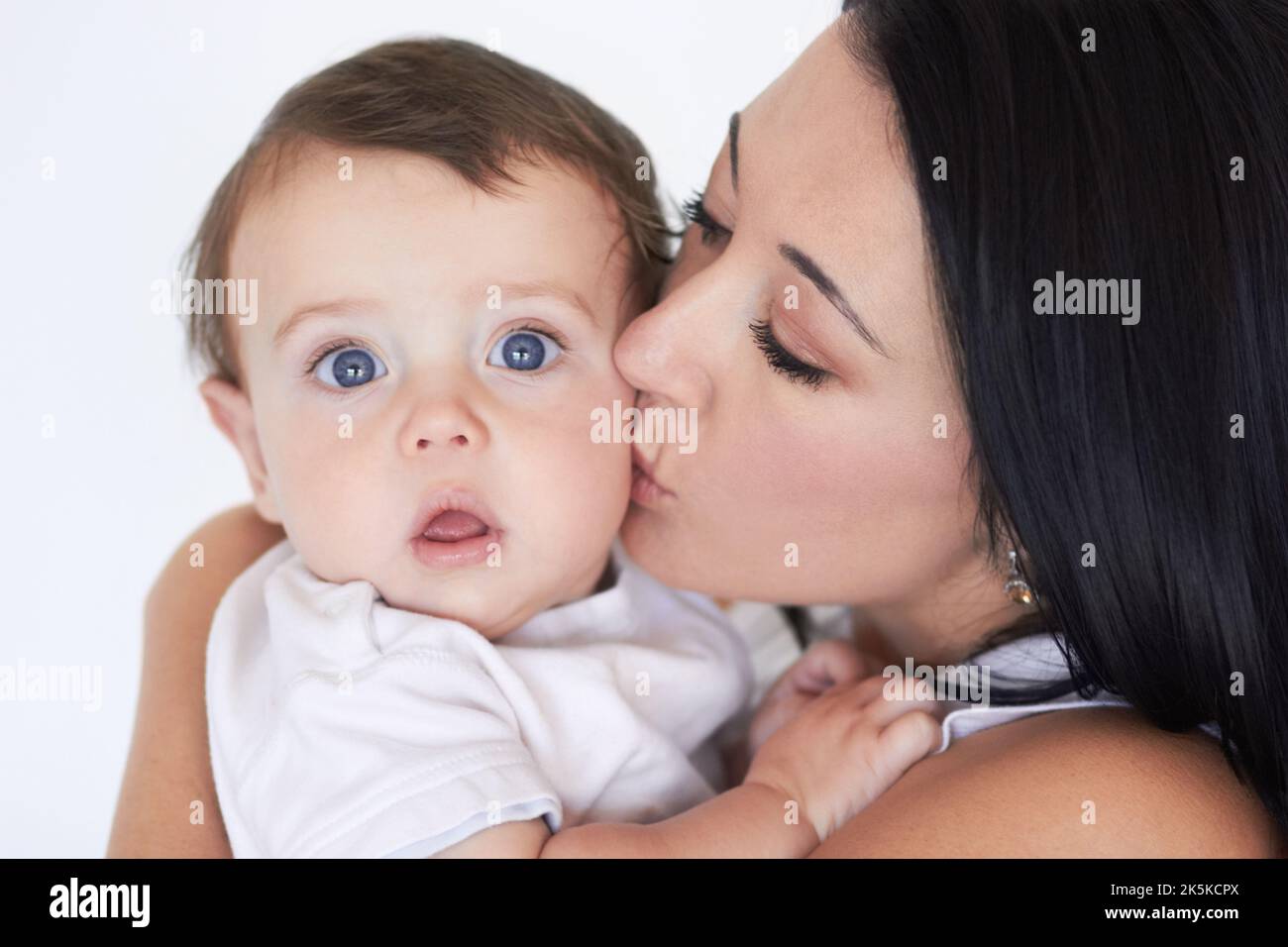 Pretty girl hugging gorgeous mother. Young, beautiful mommy and