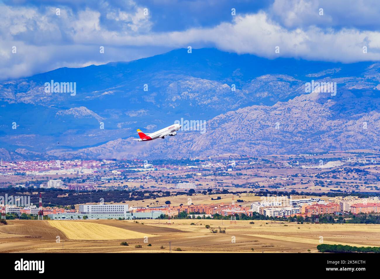 Madrid, Spain, October 30, 2022: Aircraft of the Iberia airline taking off next to the mountains surrounding Madrid. Stock Photo