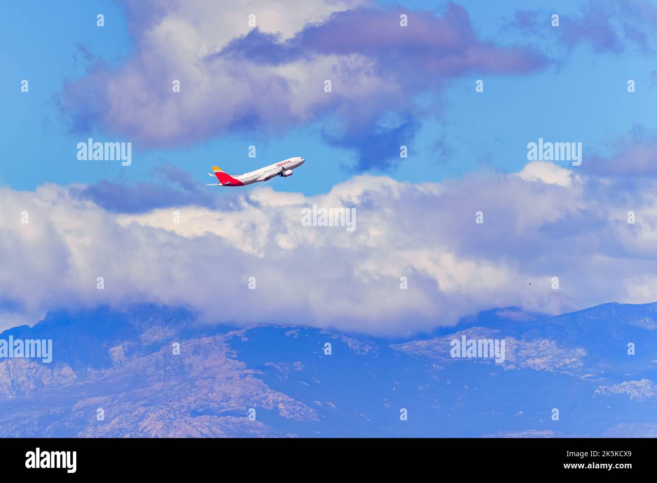 Madrid, Spain, October 30, 2022: Plane of the airline Iberia flying over the mountains of central Spain. Stock Photo