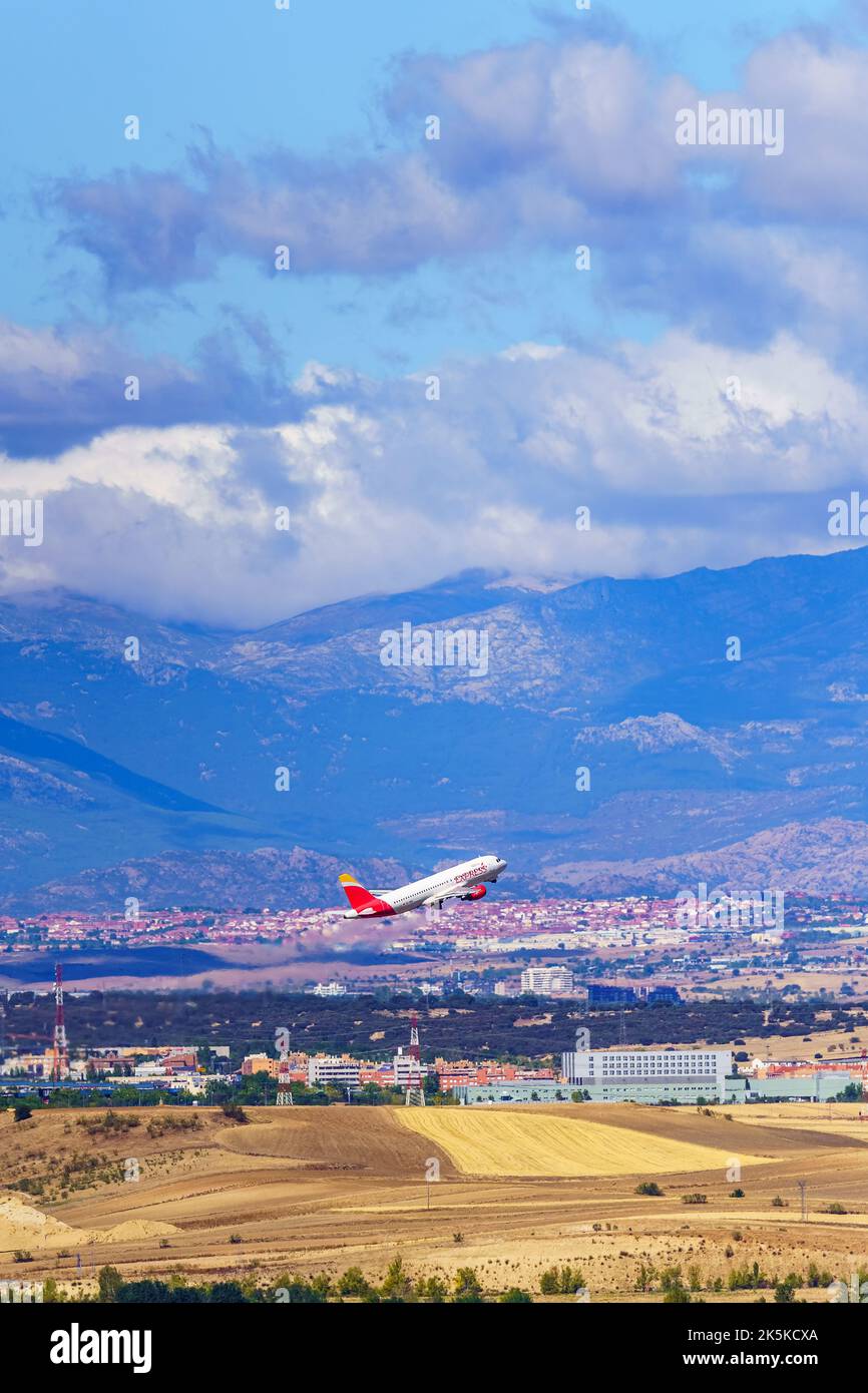Madrid, Spain, October 30, 2022: Aircraft of the Iberia airline taking off next to the mountains surrounding Madrid. Stock Photo