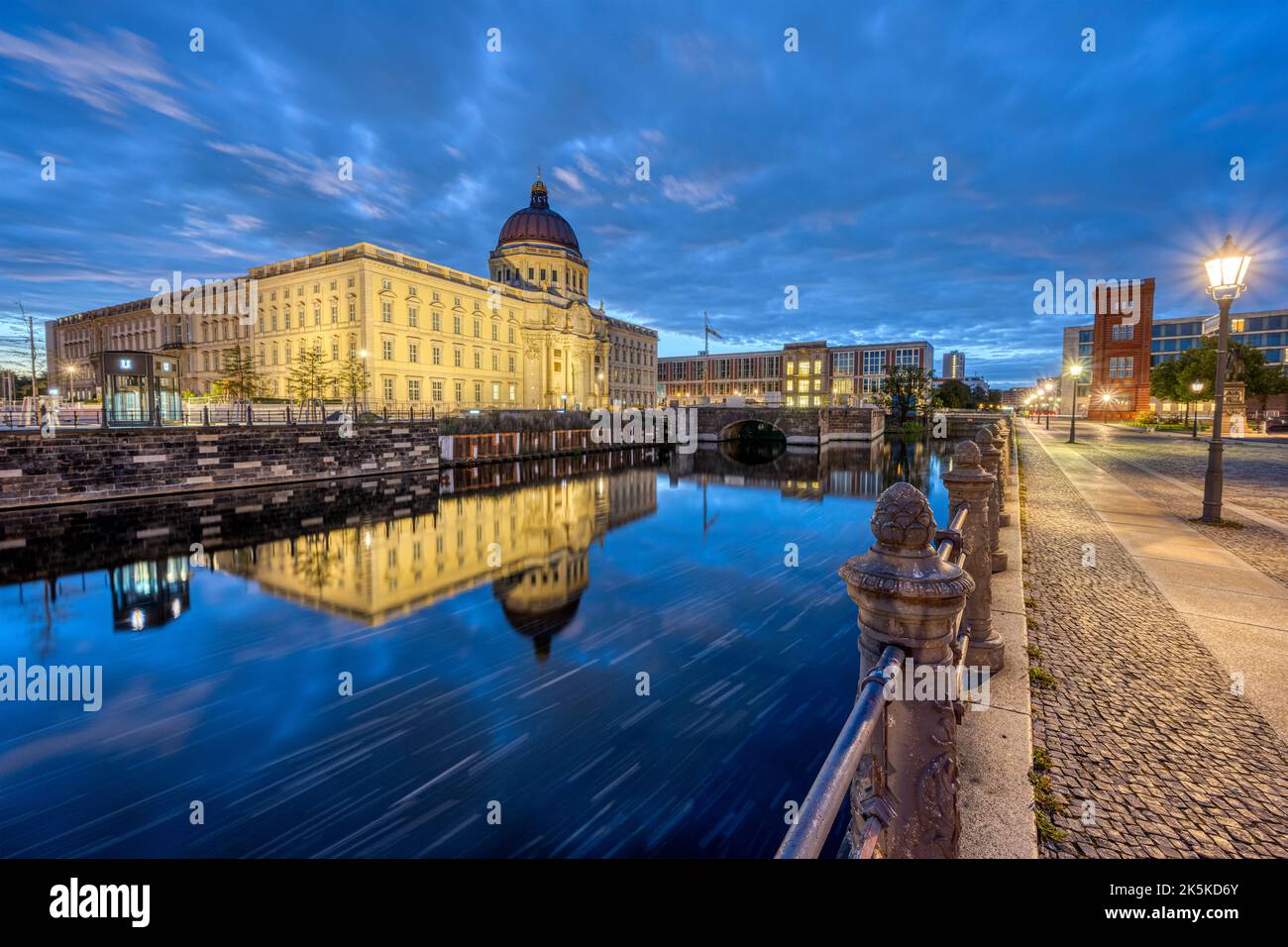 The rebuilt Berlin City Palace reflected in a small canal before sunrise Stock Photo