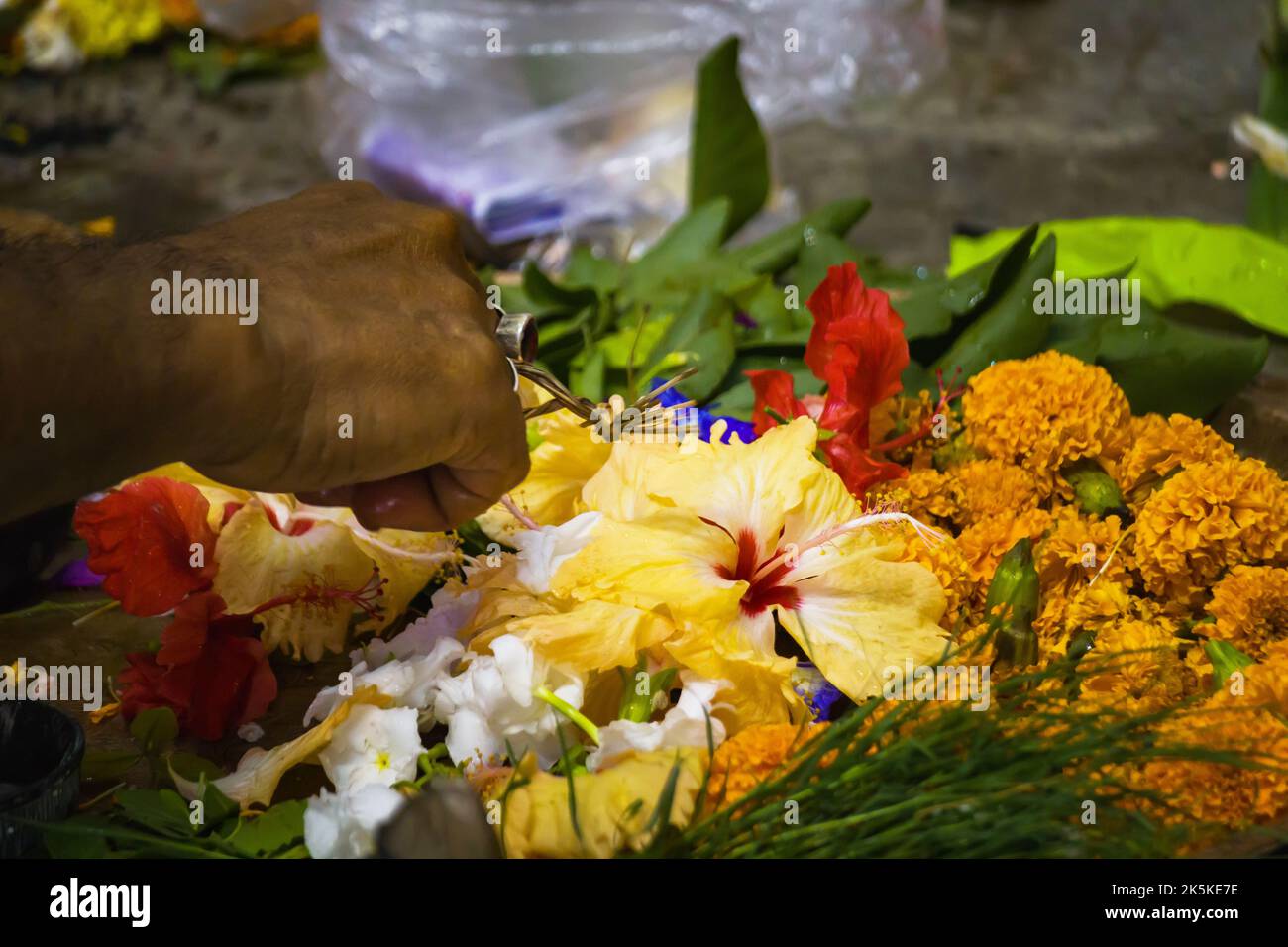 puja rituals being performed by hindu priest with flowers like china