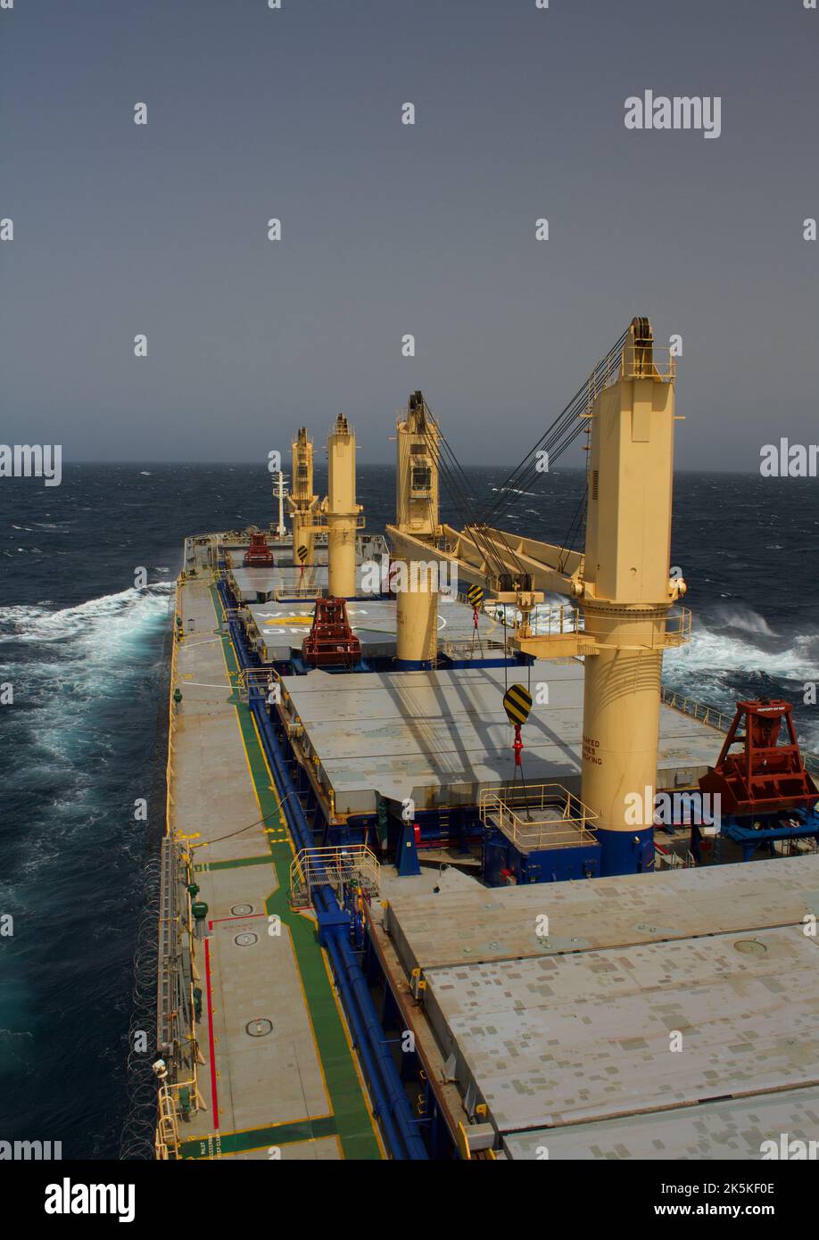 Merchant ship carrying bulk cargo is underway at sea in rough weather Stock Photo