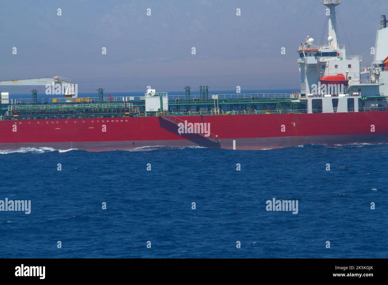 View of the bow of a merchant ship carrying chemicals is underway at sea in calm weather Stock Photo