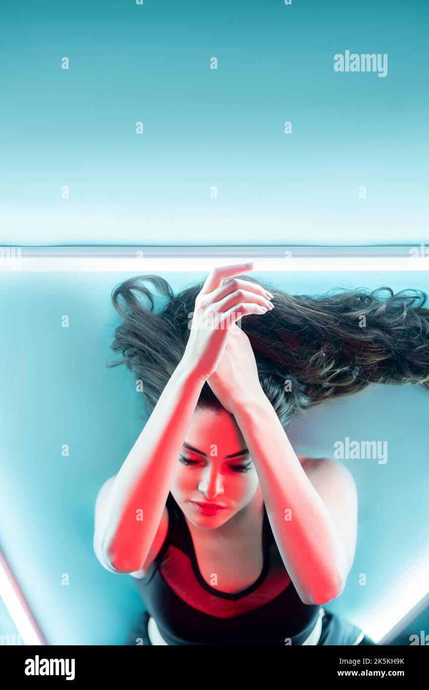 Light therapy. Solarium procedure. Body treatment. Red neon light