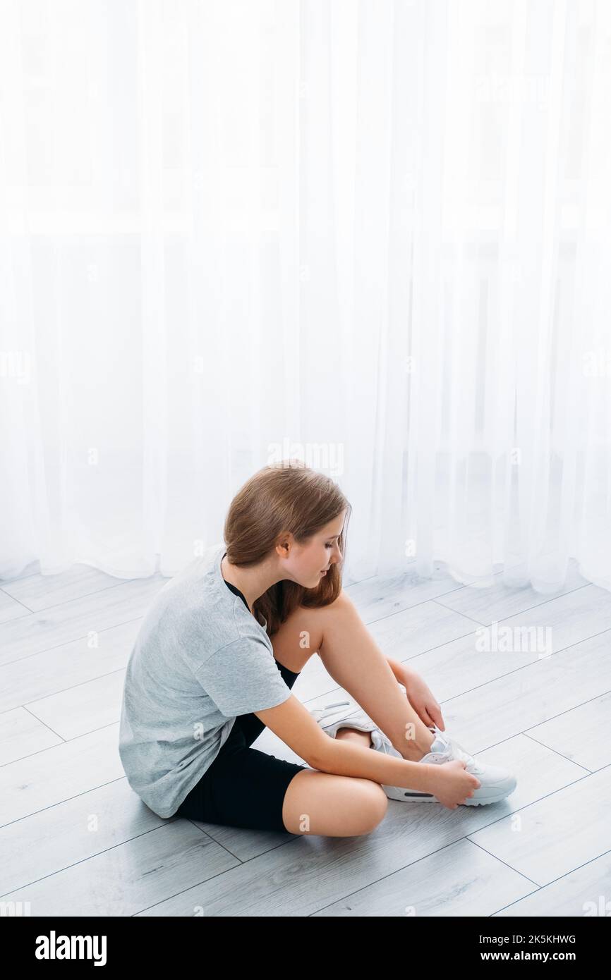 Image showcasing active children home fitness girl tying shoelace Stock Photo - Alamy