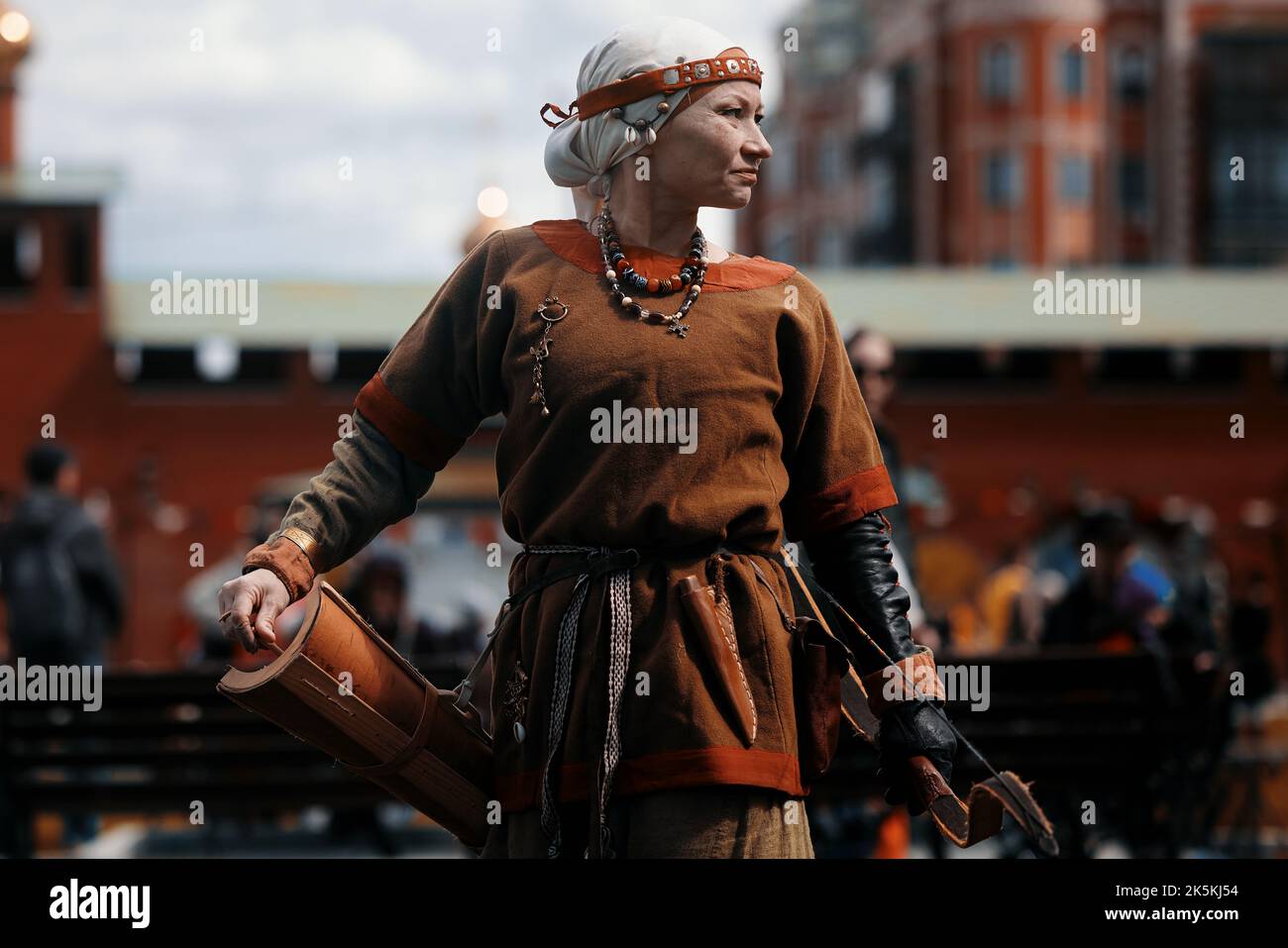 Medieval archery tournament. A woman shoots an arrow in the medieval
