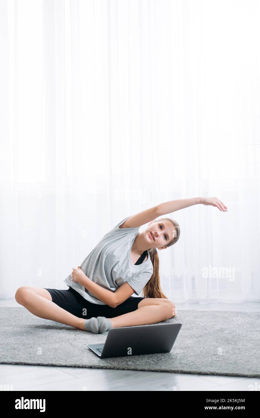 pilates online home fitness training girl laptop Stock Photo