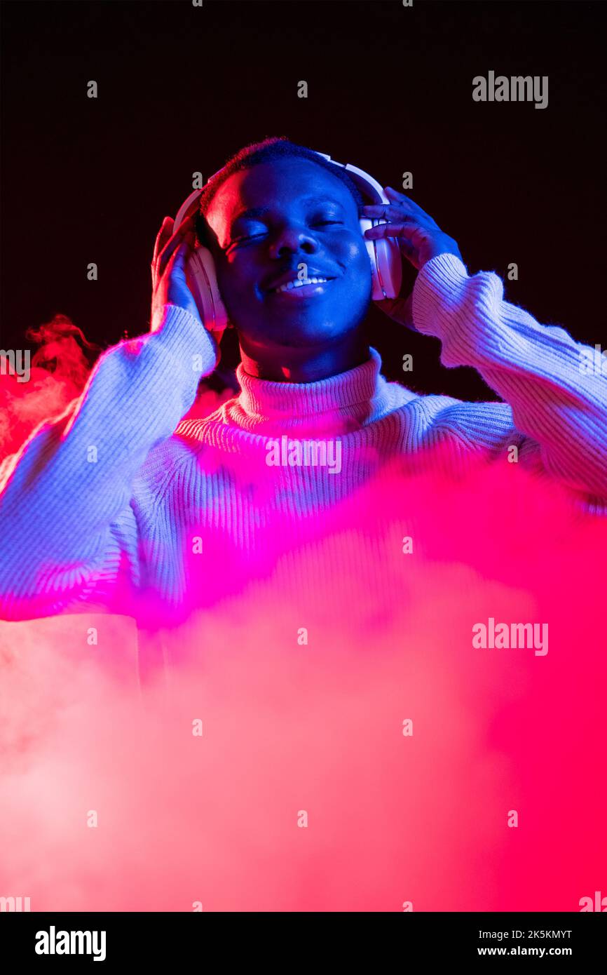 music joy wireless headphones song man neon light Stock Photo Alamy