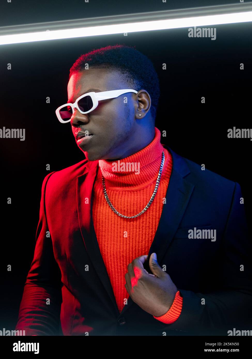man fashion model stylish suit macho neon light Stock Photo