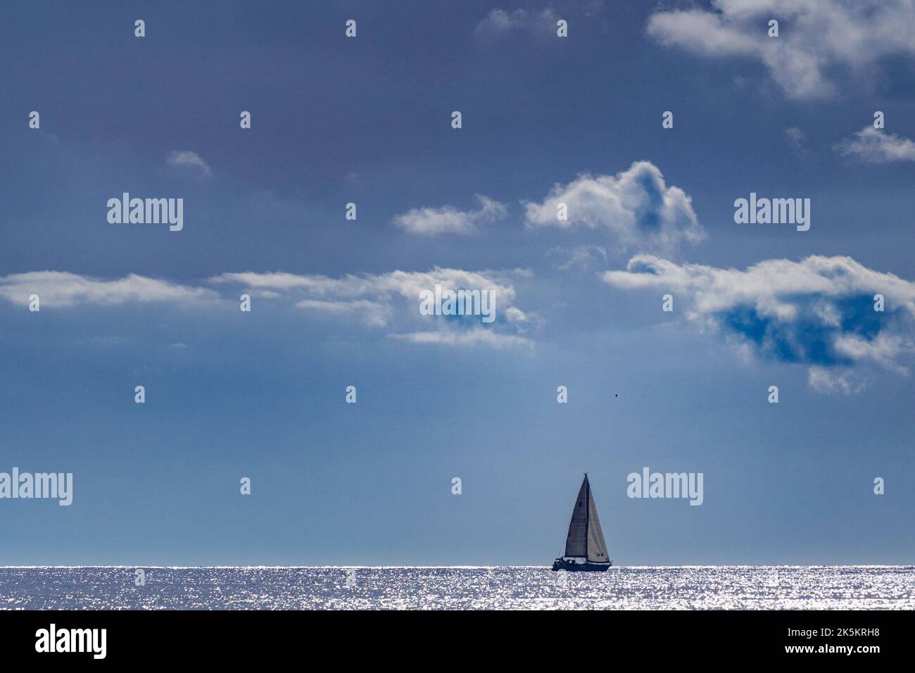 Sailing boat on the Horizon Stock Photo - Alamy