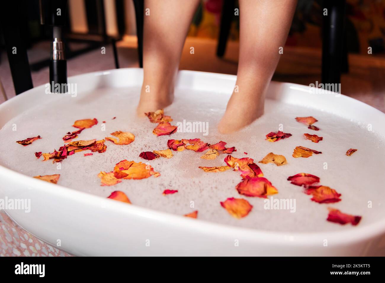 female feet put in a bucket for a pedicure Stock Photo Alamy