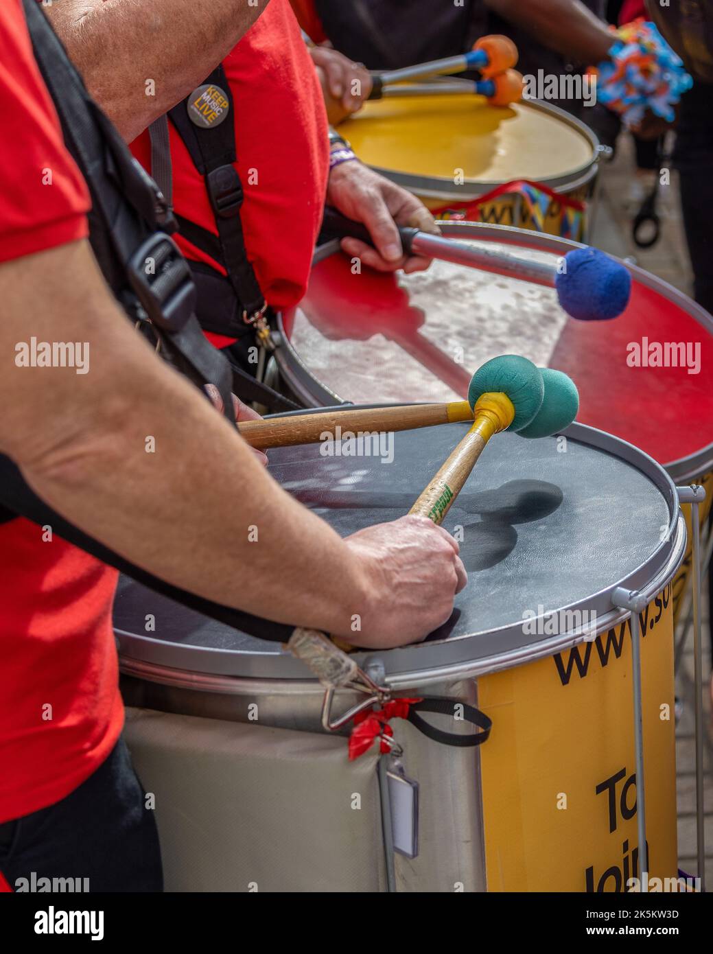 Detail of a group of marching band drummers holding their sticks just