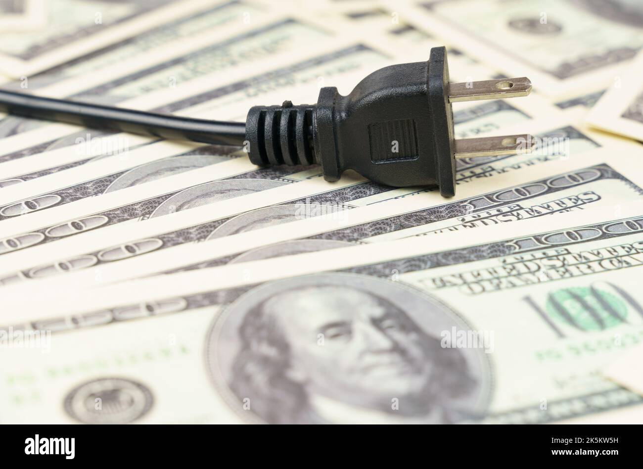 There is an electric plug on the dollar bills. The concept of the cost