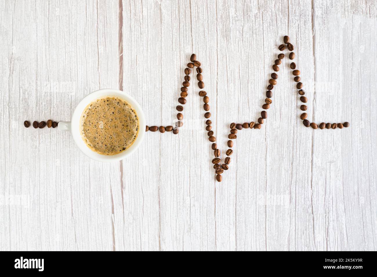Espresso coffee on table with coffee beans like heart rhythm Stock Photo