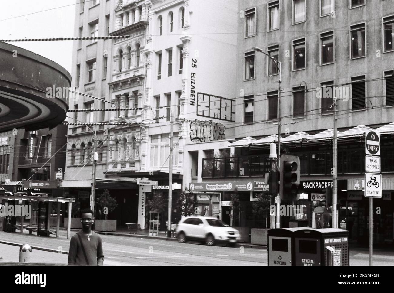 A grayscale of Elizabeth street in Melbourne with various buildings