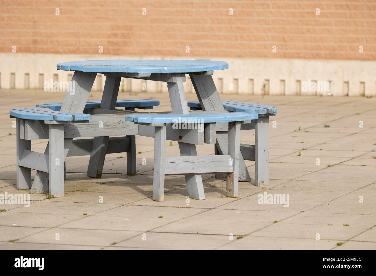 A Round Wooden Outdoor Picnic Table with Seats Stock Photo - Alamy